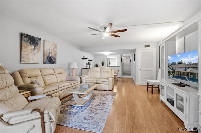 living room with ceiling fan and light wood-type flooring