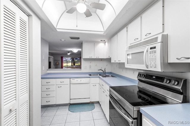 kitchen with sink, white appliances, white cabinets, and ceiling fan