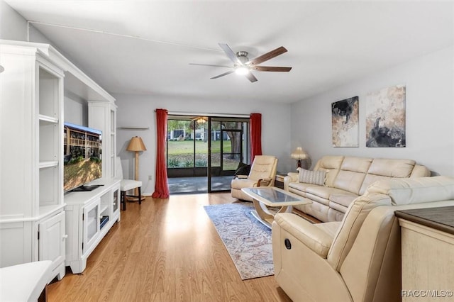 living room featuring ceiling fan and light hardwood / wood-style floors