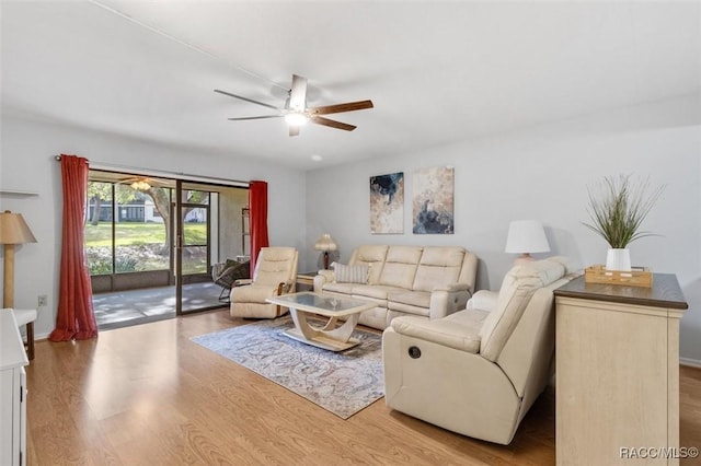 living room featuring light hardwood / wood-style floors and ceiling fan