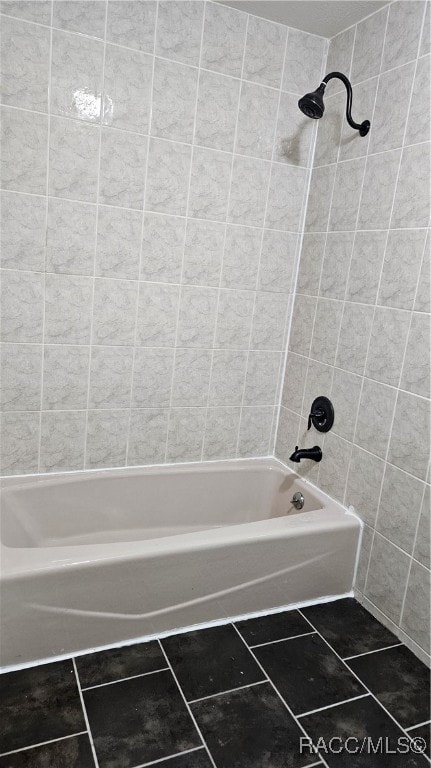 bathroom with tile patterned floors and tiled shower / bath