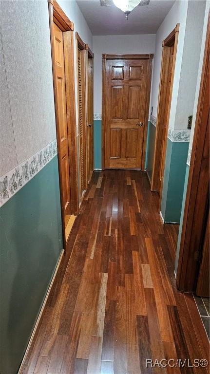 hall with dark hardwood / wood-style flooring