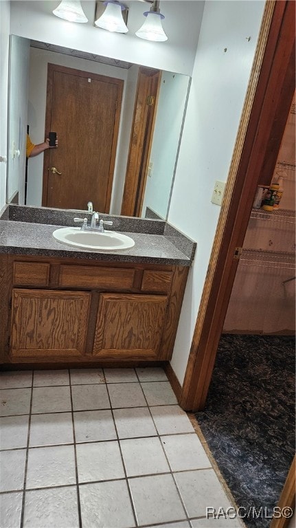 bathroom featuring tile patterned flooring and vanity