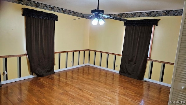 unfurnished room with hardwood / wood-style floors and ceiling fan