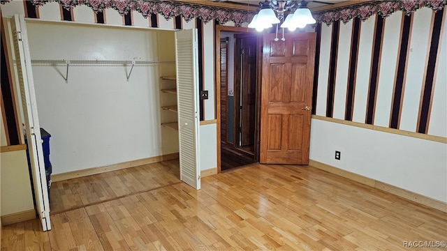 unfurnished bedroom featuring a closet and light wood-type flooring