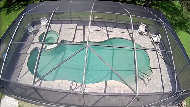 view of swimming pool with an in ground hot tub