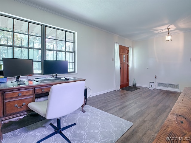 home office with wood-type flooring and ornamental molding