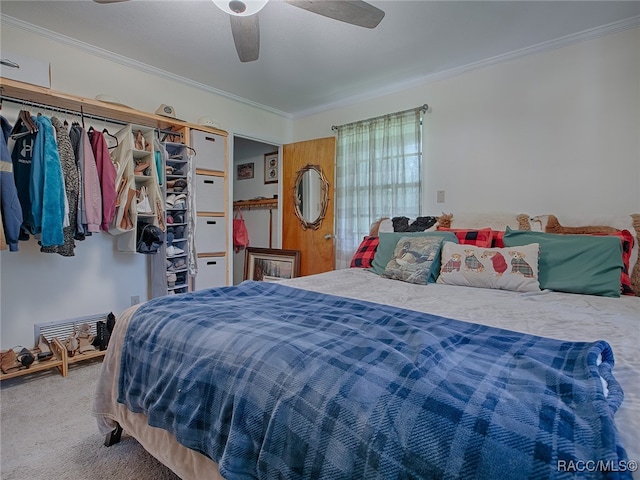 carpeted bedroom with ceiling fan and crown molding