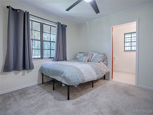 carpeted bedroom featuring ceiling fan and crown molding