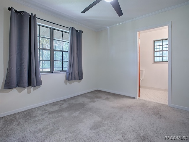 carpeted spare room with crown molding and ceiling fan