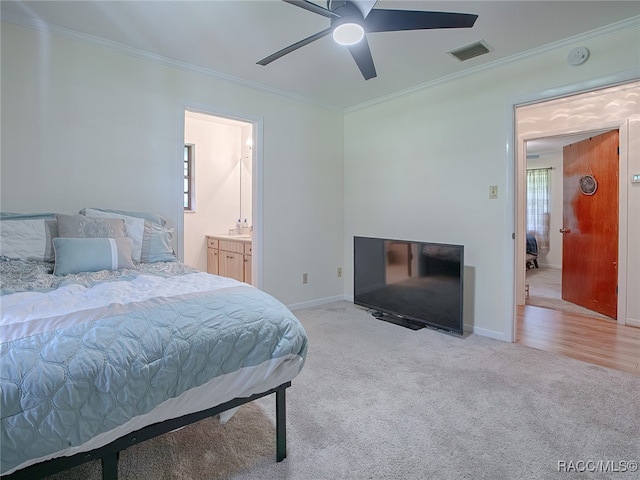 carpeted bedroom featuring connected bathroom, ceiling fan, and crown molding