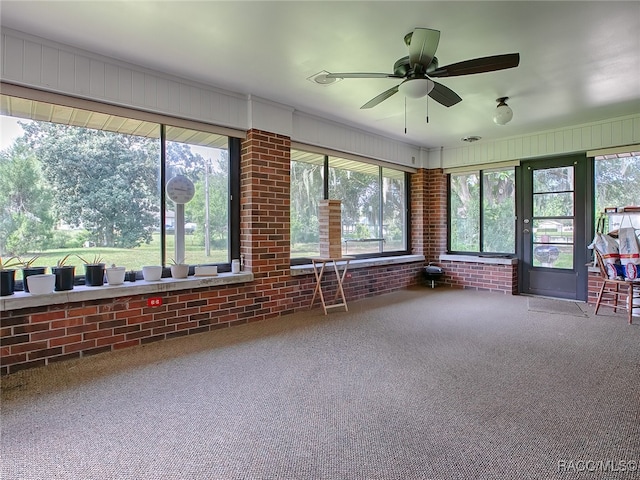 unfurnished sunroom with ceiling fan