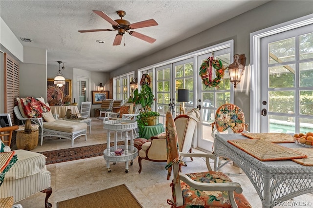 interior space with ceiling fan, plenty of natural light, and french doors