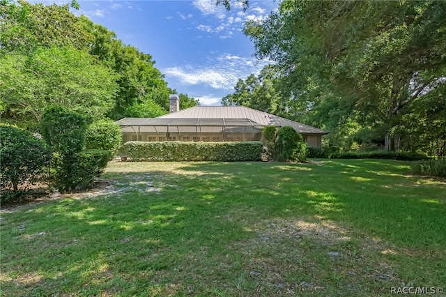 view of yard featuring glass enclosure