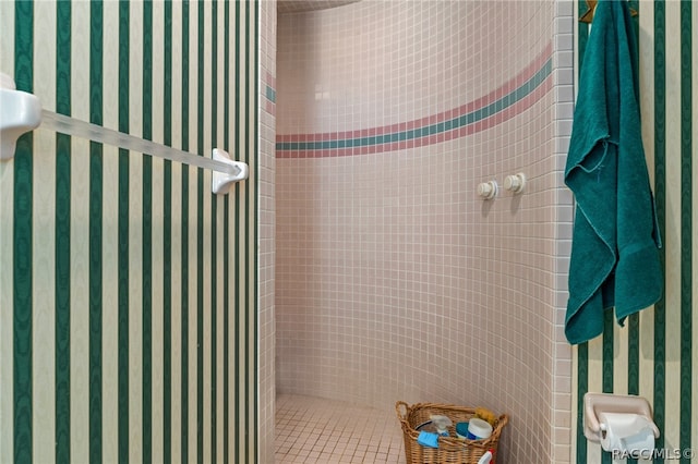 bathroom with a tile shower