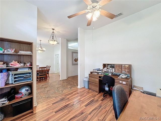 office space with hardwood / wood-style flooring and ceiling fan with notable chandelier