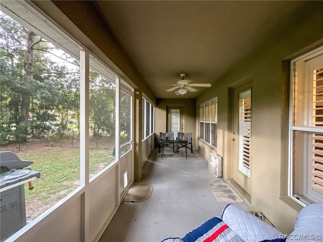 sunroom / solarium featuring ceiling fan