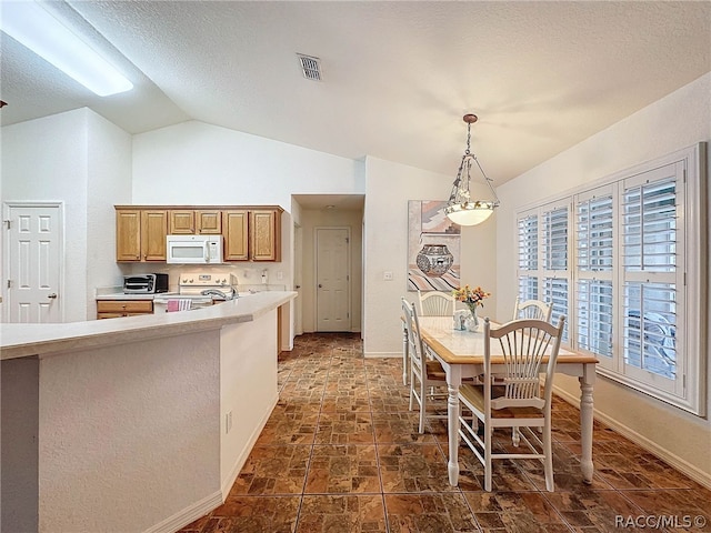 kitchen with pendant lighting, electric stove, and vaulted ceiling