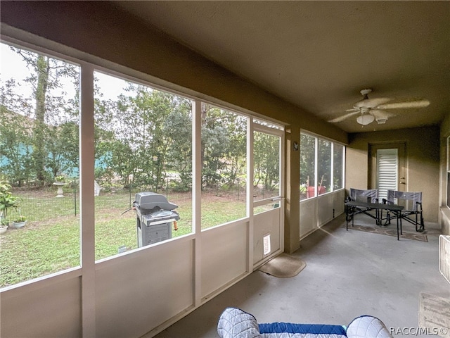 sunroom featuring ceiling fan