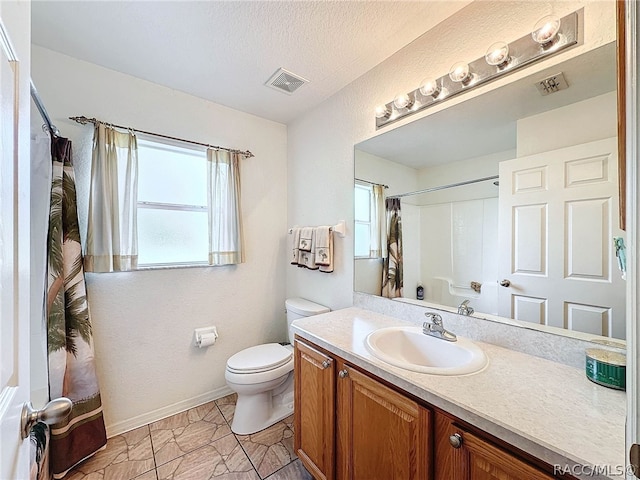 bathroom with a shower with shower curtain, vanity, toilet, and a textured ceiling