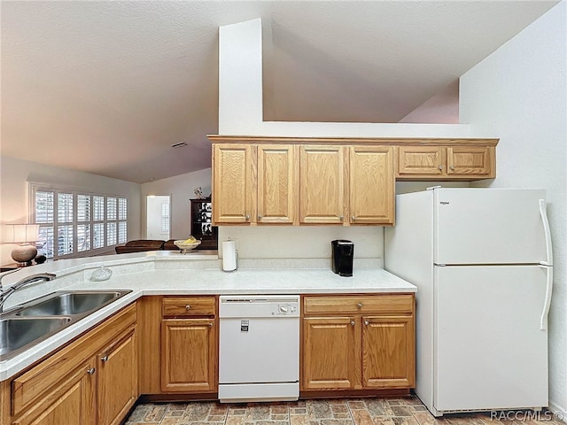 kitchen featuring kitchen peninsula, white appliances, vaulted ceiling, and sink