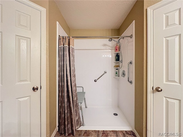 bathroom with a textured ceiling and walk in shower