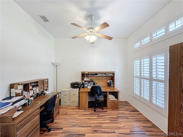 home office featuring light wood-type flooring and ceiling fan