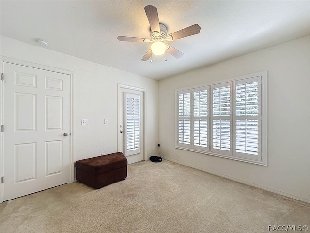 carpeted spare room with ceiling fan and a textured ceiling