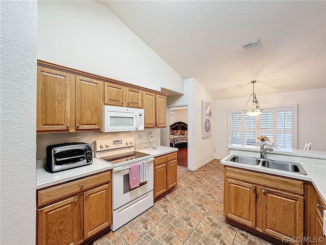 kitchen with white appliances, an inviting chandelier, sink, hanging light fixtures, and a textured ceiling