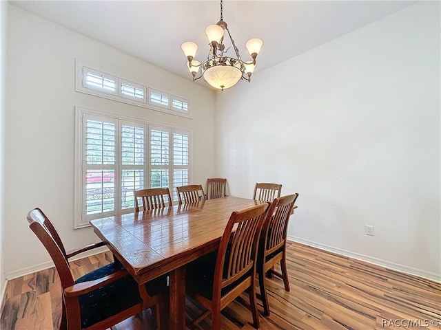 dining area with an inviting chandelier and hardwood / wood-style flooring