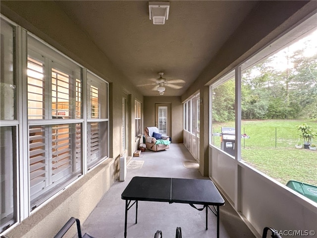 sunroom / solarium featuring ceiling fan