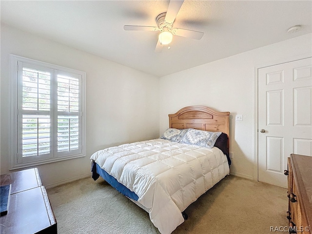 bedroom featuring ceiling fan and light colored carpet