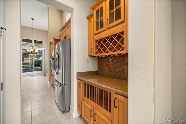 1789 N Sky Glen Path, Hernando, FL 34442 - kitchen with an inviting chandelier, glass insert cabinets, tasteful backsplash, appliances with stainless steel finishes, and light tile patterned flooring