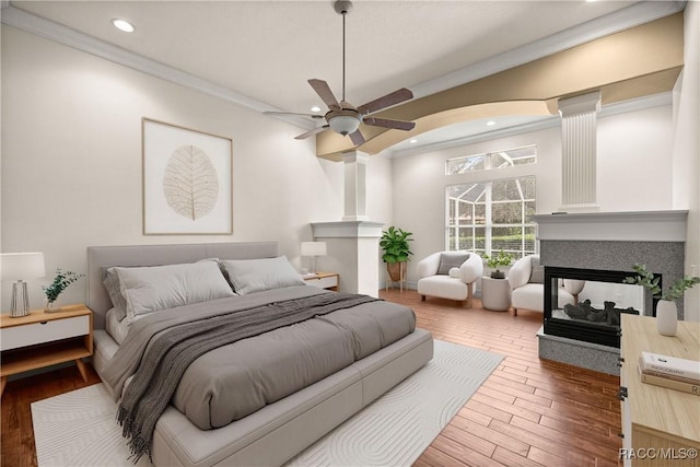 1789 N Sky Glen Path, Hernando, FL 34442 - bedroom featuring crown molding, recessed lighting, a multi sided fireplace, and wood finished floors