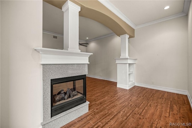 1789 N Sky Glen Path, Hernando, FL 34442 - unfurnished living room featuring crown molding, decorative columns, and wood finished floors