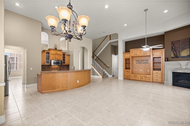 1789 N Sky Glen Path, Hernando, FL 34442 - kitchen with glass insert cabinets, baseboards, arched walkways, ceiling fan with notable chandelier, and stainless steel appliances