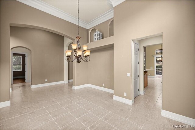 1789 N Sky Glen Path, Hernando, FL 34442 - unfurnished dining area with a notable chandelier, baseboards, ornamental molding, light tile patterned flooring, and arched walkways