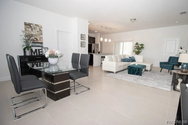 dining area featuring a chandelier and tile patterned floors