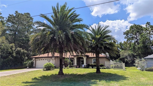 3340 W Eldridge Dr, Citrus Springs, FL 34433 - view of front of home featuring a garage, driveway, and stucco siding