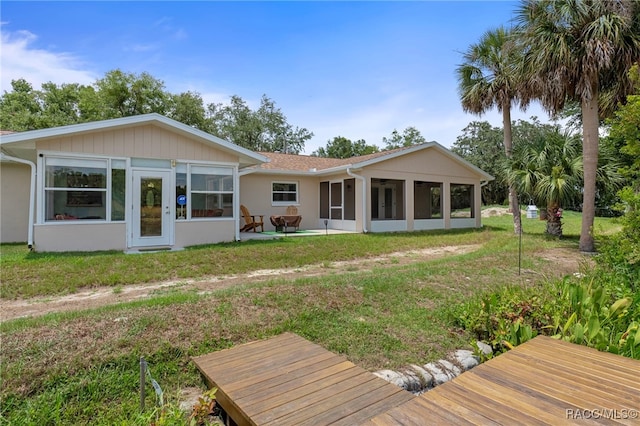 4306 E Gloria Dr, Hernando, FL 34442 - back of house featuring a sunroom and a lawn