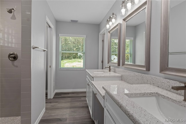 4306 E Gloria Dr, Hernando, FL 34442 - bathroom with double vanity, a tile shower, and wood finished floors