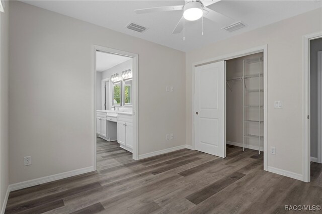 4306 E Gloria Dr, Hernando, FL 34442 - unfurnished bedroom featuring wood finished floors, a closet, connected bathroom, and ceiling fan