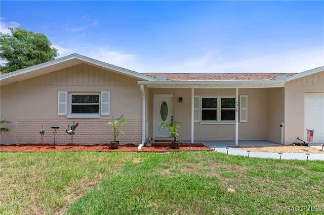 4306 E Gloria Dr, Hernando, FL 34442 - ranch-style home with an attached garage, a front lawn, brick siding, and roof with shingles