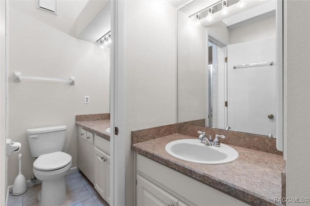 bathroom with tile patterned floors, vanity, and toilet