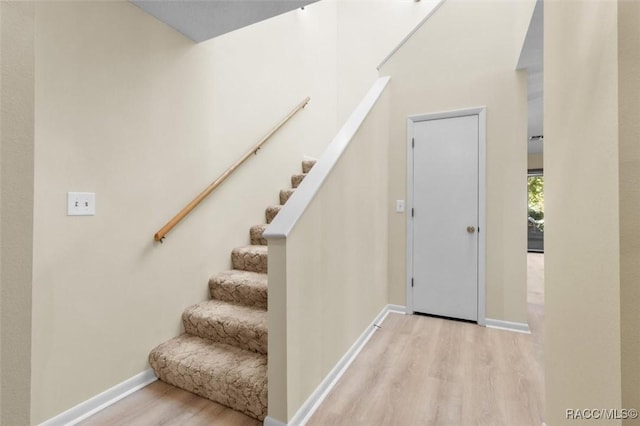 stairs with hardwood / wood-style floors