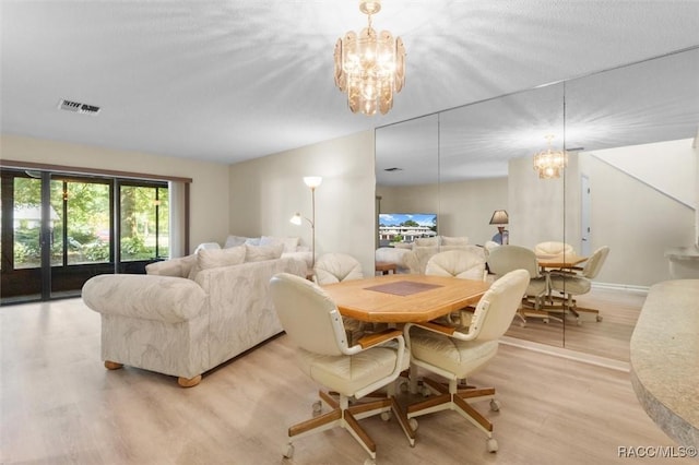 dining space with light hardwood / wood-style flooring