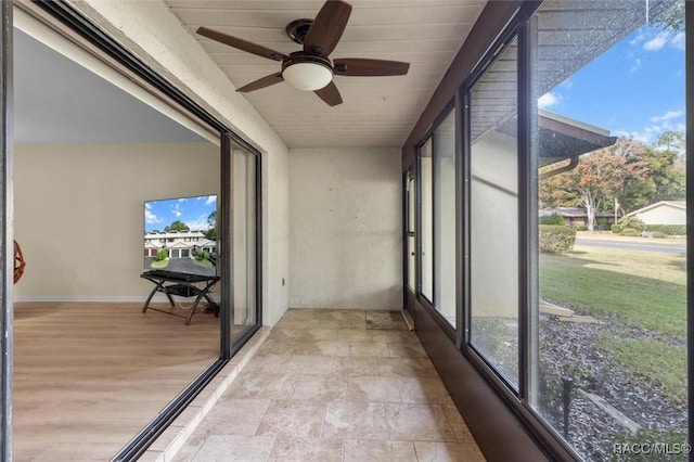 sunroom with a wealth of natural light and ceiling fan