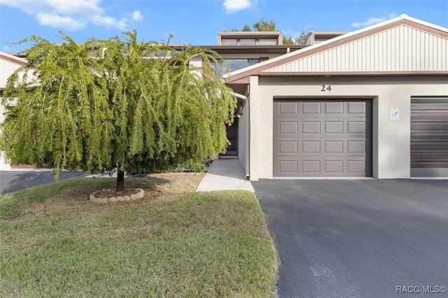 view of front of property with a garage and a front lawn