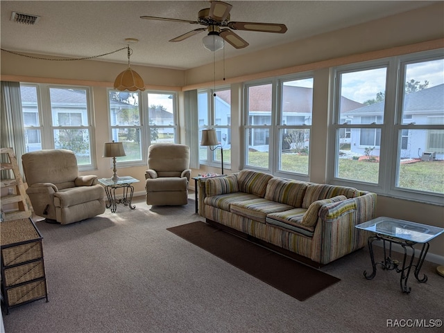 sunroom / solarium featuring ceiling fan and a healthy amount of sunlight