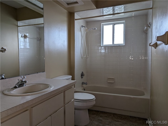 full bathroom featuring tile patterned floors, vanity, toilet, and tiled shower / bath